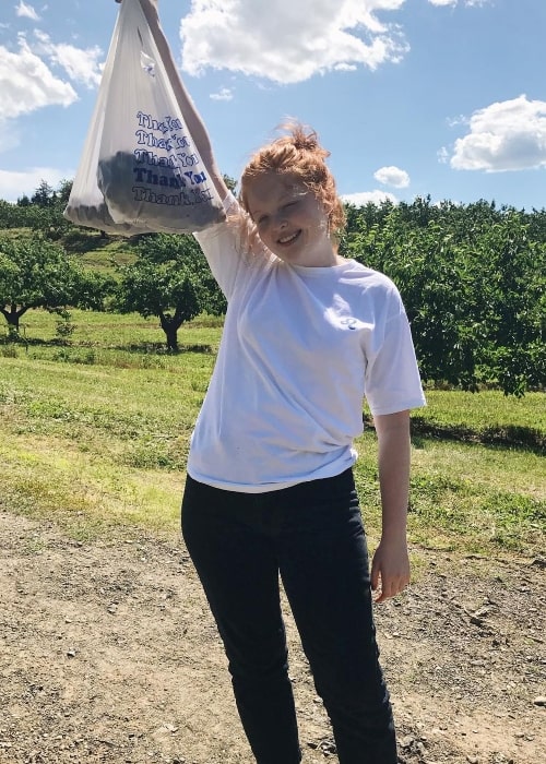 Tess McMillan posing after picking some cherries with her mom in June 2017
