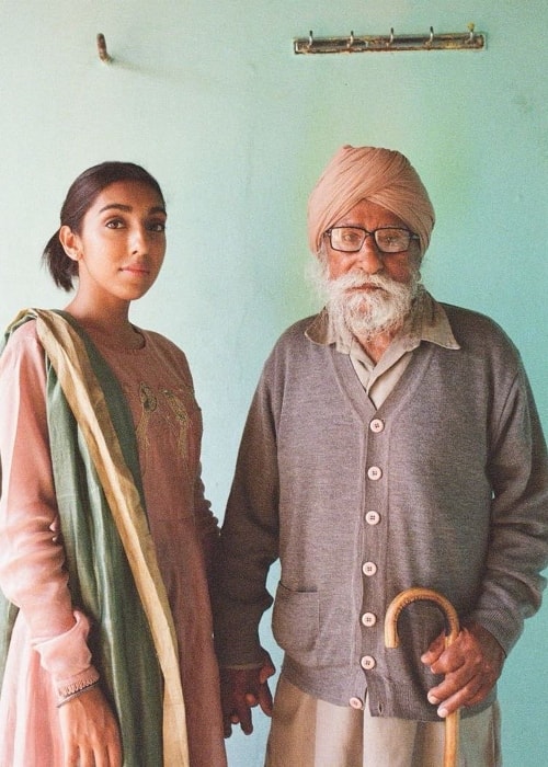 Rupi Kaur posing with her last living grandparent, her maternal grandfather, in her homeland of Punjab, India in April 2018