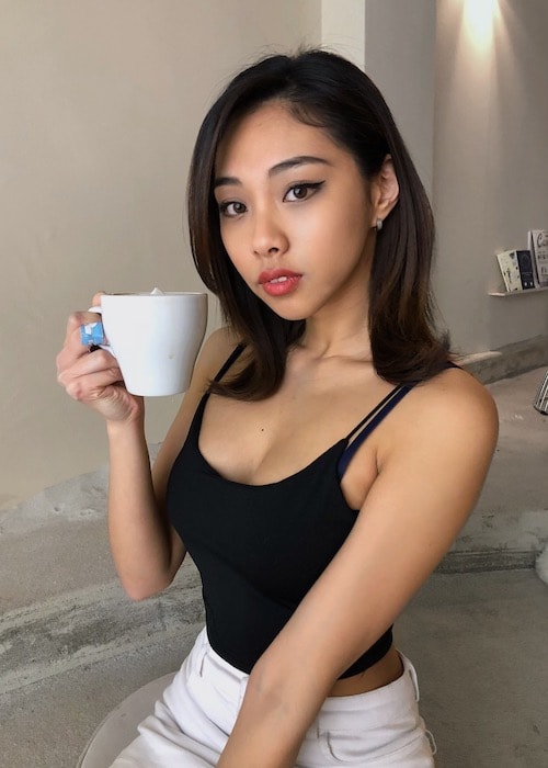 Stacey Kim drinking a hot beverage