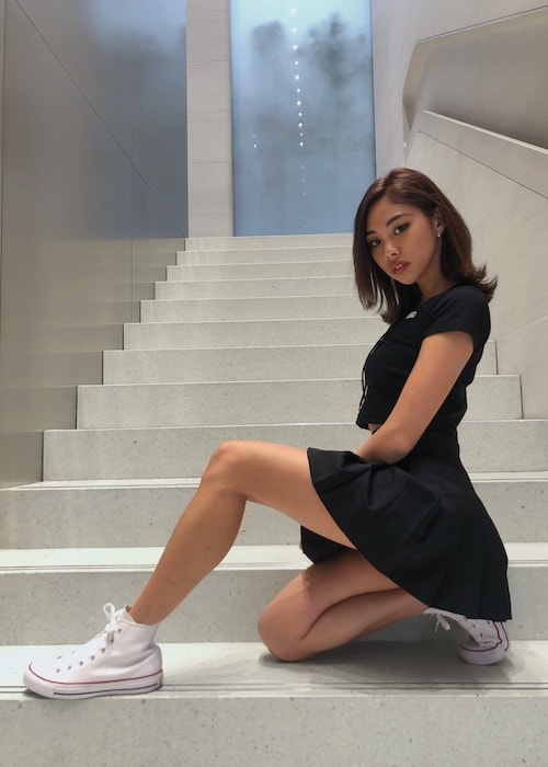 [Image: Stacey-Kim-posing-on-the-stairs.jpeg]