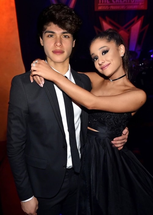 Alan Stokes as seen while all suited up and posing for a picture with singer, songwriter, and actress, Ariana Grande, in May 2019