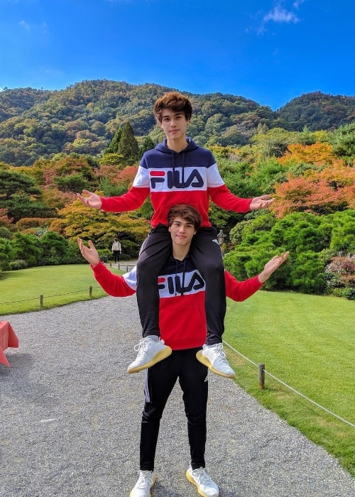 Alex Stokes as seen while carrying his older twin brother, Alan Stokes, on his shoulders and posing for a picture in November 2018