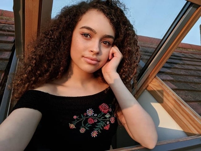 Mya-Lecia Naylor as seen while taking a Golden-hour selfie by popping out of the window in April 2018