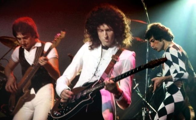 Queen band members Brian May, Freddie Mercury, and John Deacon performing in Connecticut in 1977