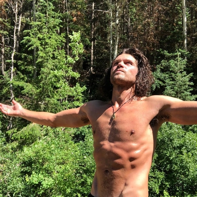 Trent Garrett as seen while posing shirtless for a picture in the woods in Park City, Utah, United States in June 2018