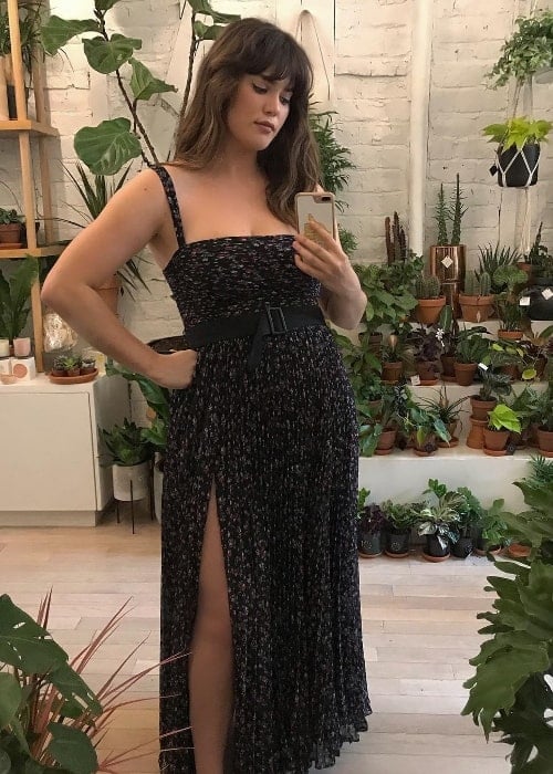 Ali Tate as seen while taking a mirror selfie in a stunning dress while being surrounded by plants in May 2019