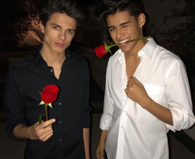 Andrew Davila as seen wearing a white shirt and posing for the camera alongside his friend, Brent Rivera, in February 2019