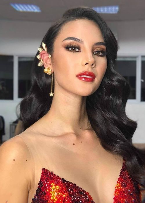 Catriona Gray wearing the iconic tri-star and sun earpiece with a Swarovski gem embellished Mayon gown by designer Mak Tumang