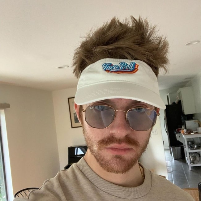 Finneas O'Connell as seen while taking a selfie wearing a 'Taco Bell' cap and a pair of shades in May 2019