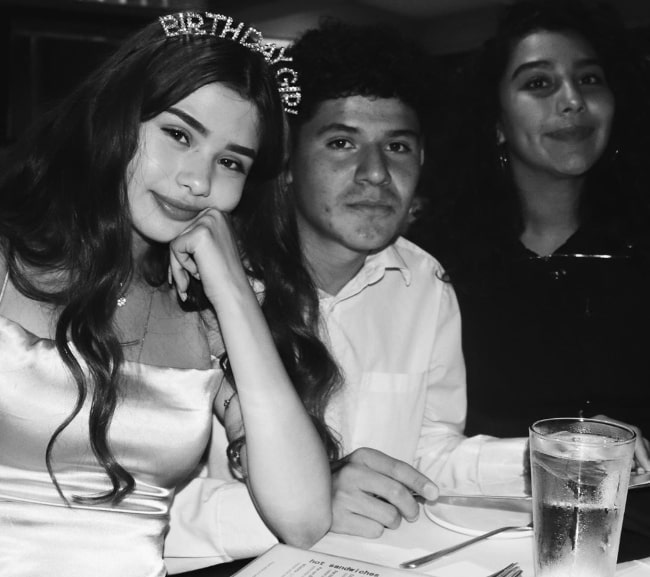 Priscilla Barrera (Corner Left) as seen in a black-and-white picture with her friends, Michael and Caro, celebrating her 16th birthday while wearing a tiara in May 2019