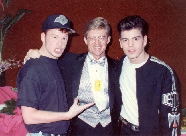 Jordan Knight and Donnie Wahlberg posing backstage at the 1990 Grammy Awards
