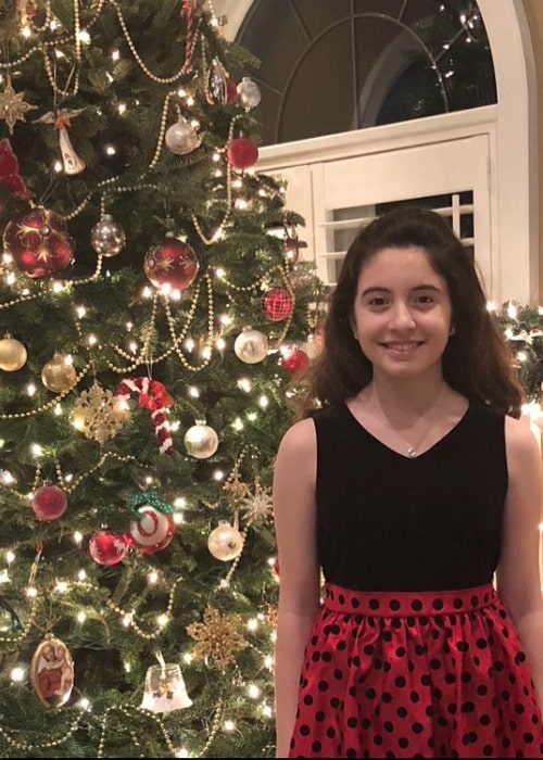 Olivia Presti as seen while posing in front of a Christmas tree during the holidays in December 2017