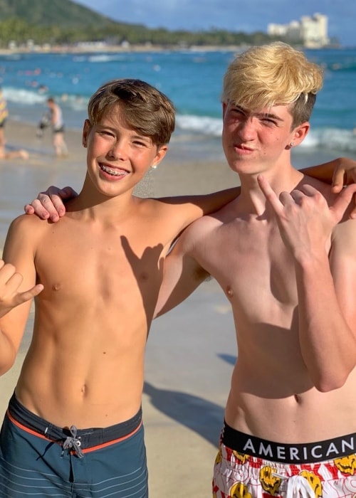 Caleb Coffee (Left) as seen shirtless while posing for a picture along with Cash Baker in July 2019