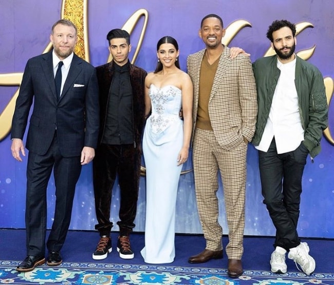 From Left to Right - Guy Ritchie, Mena Massoud, Naomi Scott, Will Smith, and Marwan Kenzari as seen while posing for a picture during an event in London, England, United Kingdom in May 2019