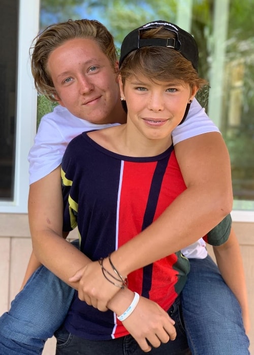 Isaac Coffee as seen while posing for the camera while being carried on the back by his younger brother, Caleb Coffee, in April 2019