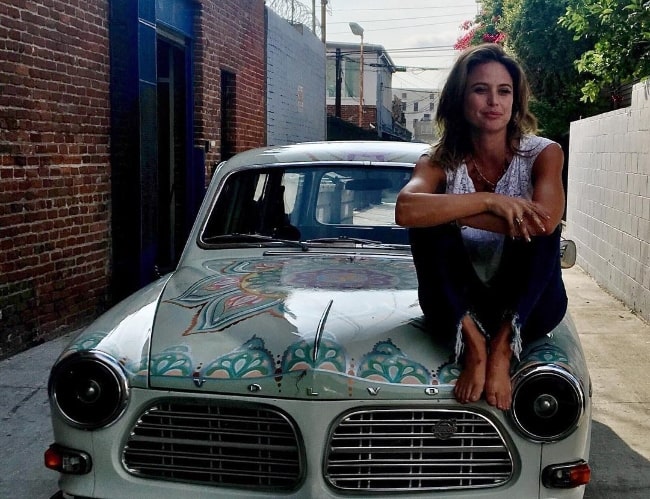 Josie Maran as seen while posing for a picture with her mandala-painted 1960s Volvo Station Wagon