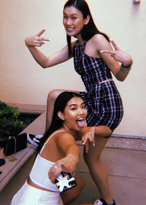 Phi Tran as seen in a white outfit while posing for a goofy picture along with Jaclyne Nguyen in September 2018 in Los Angeles, California, United States