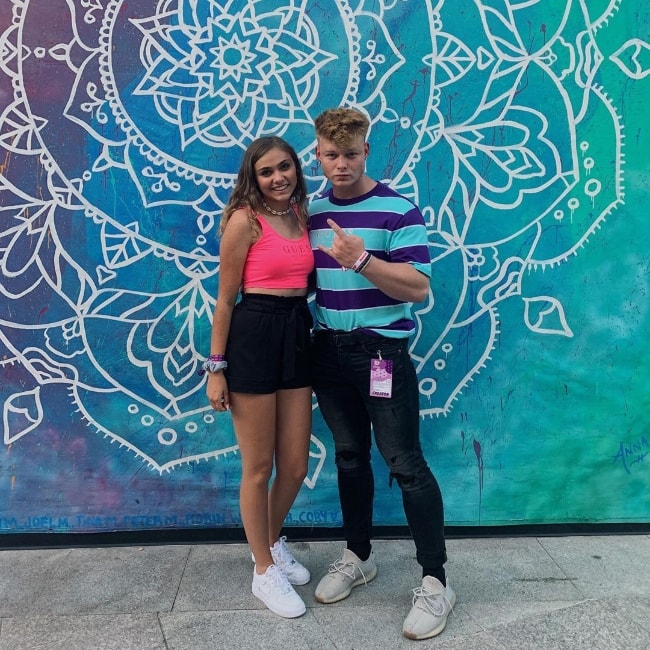 Ariana Lee Bonfiglio as seen while posing for a picture along with Robert Carroll in front of a beautiful mural in July 2019