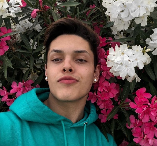 Christopher Romero as seen while taking a selfie with flowers in Los Angeles, California, United States in May 2018