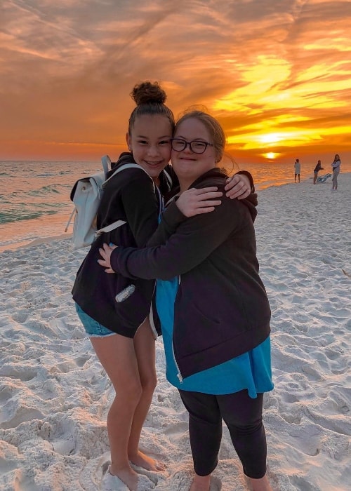 Olivia Haschak (Left) as seen while posing for a picture by the beach with a stunning backdrop along with Sarah Grace in April 2019