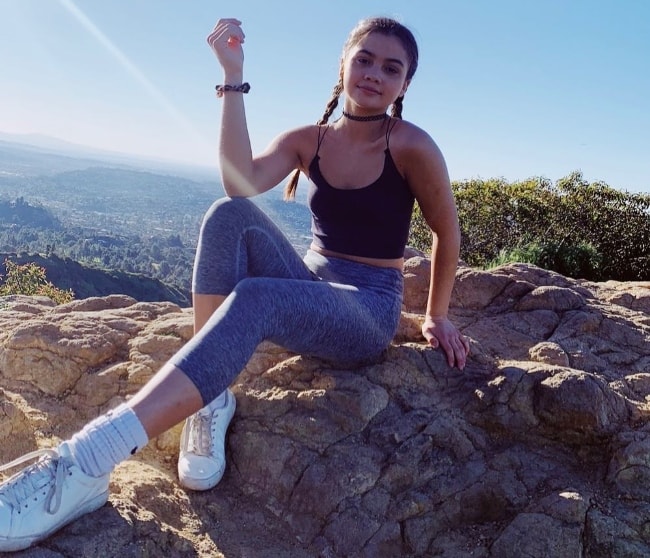 Siena Agudong as seen while posing for the camera during the hike to Hollywood Sign in Los Angeles, California, United States with Connor Finnerty in March 2019