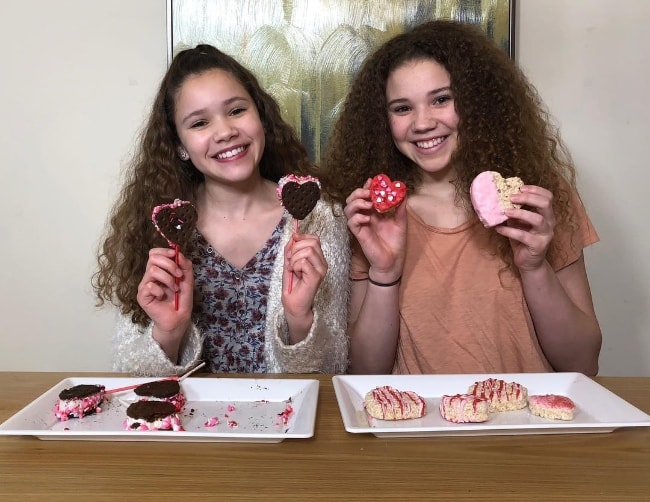 Sierra Haschak (Left) as seen while posing for a picture along with her older sister, Madison Haschak, showing their DIY Valentine’s Day Heart Treats in February 2018