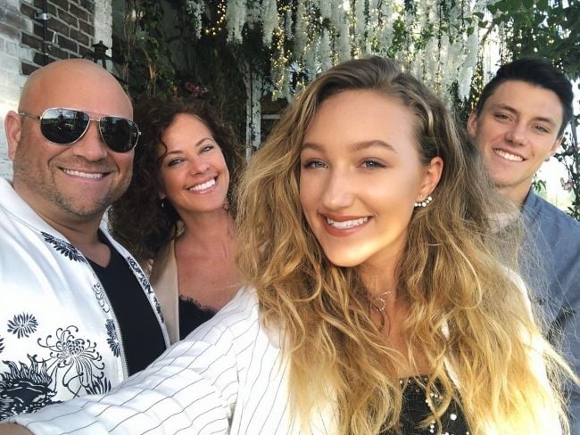 Ava posing with her family Jeanette Cota, Jason Drenner, and brother Devon Cota in May 2019