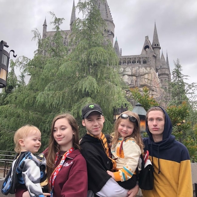 Devin Druid (Center) as seen alongside his siblings, Aidan Fiske and Alexa Fiske, while holding his niece at the Universal Studios Hollywood in Universal City, California, United States in 2019