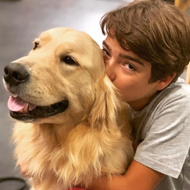 Elias Harger as seen while kissing Cosmo, the family dog on 'Fuller House', at the Warner Brothers Studios in Burbank, Los Angeles County, California, United States in July 2019