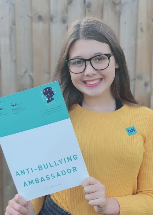 Isabelle Ingham as seen in a picture of her holding a certificate of The Diana Award's Anti-Bullying Campaign certificate of joining in October 2019