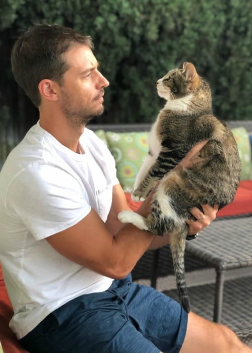 Joshua Snyder with his cat as seen in August 2019