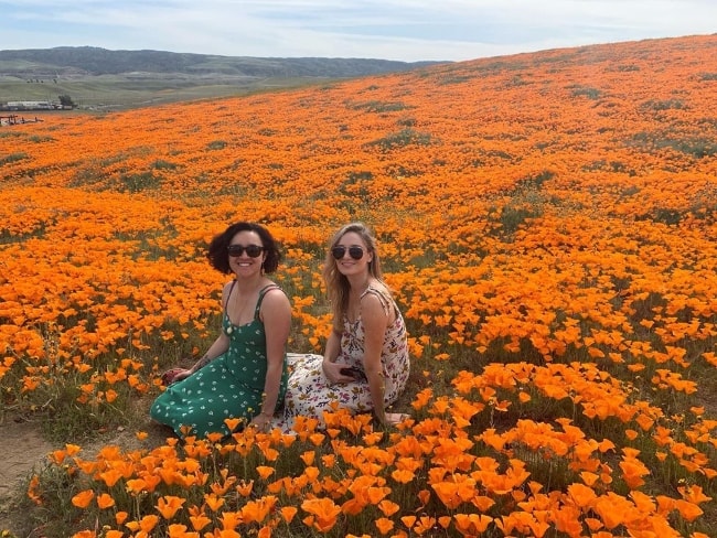 Keisha Castle-Hughes (Left) posing for a picture along with Christina Collard in Antelope Valley California Poppy Reserve located in Los Angeles County, California‎, United States in April 2019