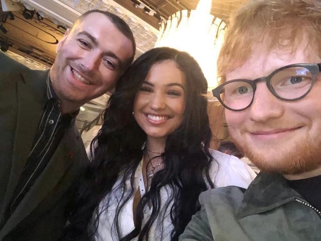 Mabel as seen while smiling in a selfie along with Ed Sheeran (Right) and Sam Smith in July 2019