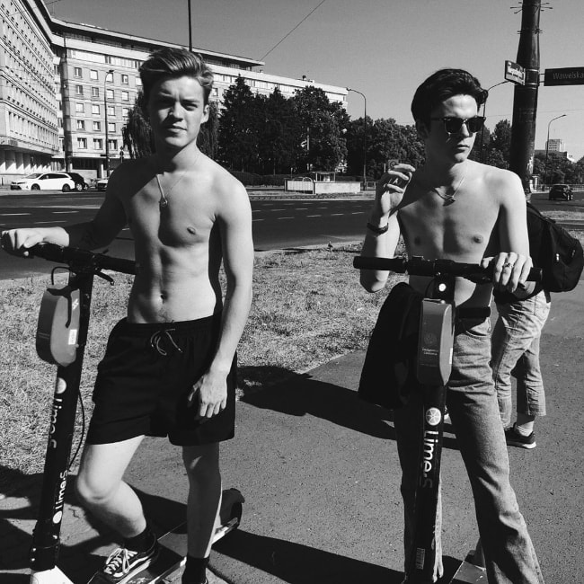 Reece Bibby (Left) as seen while posing shirtless for a black-and-white picture along with his 'New Hope Club' bandmate, Blake Richardson, in Warsaw, Poland in June 2019