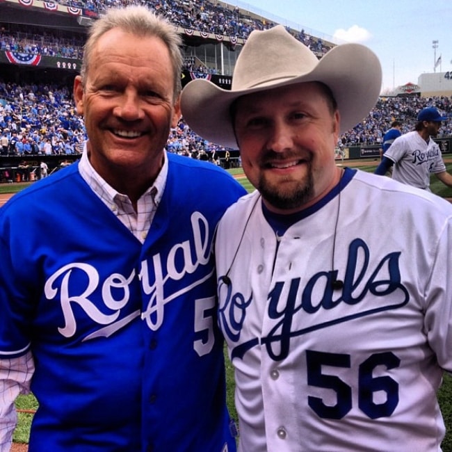 Tate Stevens (Right) as seen while posing for a picture along with baseball legend George Brett in April 2013