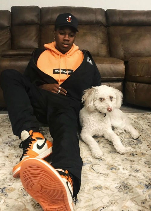 Tayvion Power with his dog as seen in July 2019