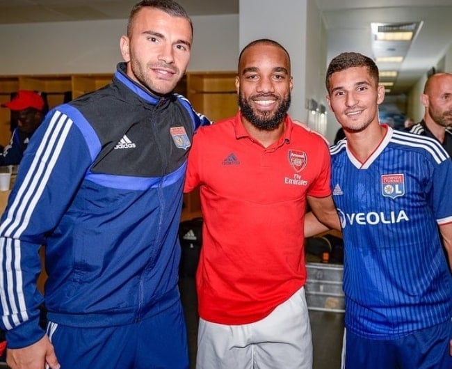 Alexandre Lacazette posing for a picture along with Anthony Lopes (Left) and Houssem Aouar (Right) at Emirates Stadium in London, England, United Kingdom in July 2019