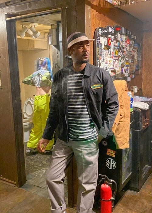 Danny Brown as seen while posing for a picture at Cervantes Masterpiece Theater with Ashnikko in the background in November 2019