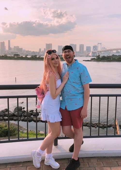 Leah Ashe as seen while posing for a picture along with Garrett in Odaiba, Tokyo, Japan in September 2019