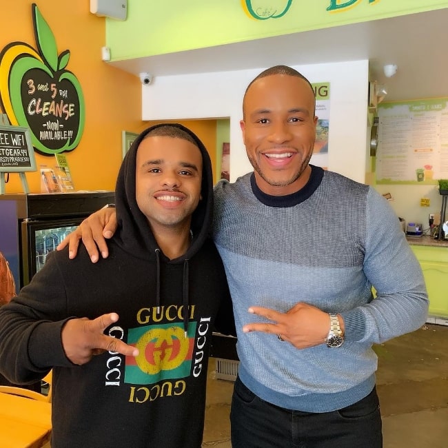 Raz-B (Left) as seen while posing for a picture alongside DeVon Franklin in February 2019