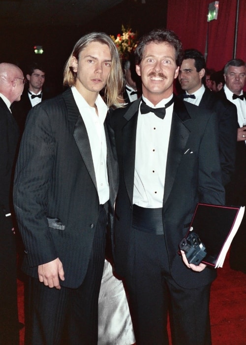 River Phoenix (Left) as seen while posing for the camera along with a fan at the 61st Academy Awards, March 29, 1989 - Governor's Ball