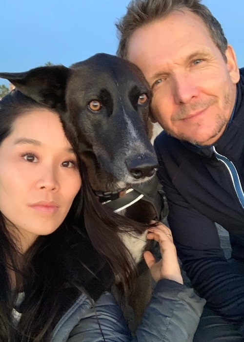 Sebastian Roché as seen while posing for a selfie along with Alicia Hannah and their dog in December 2018