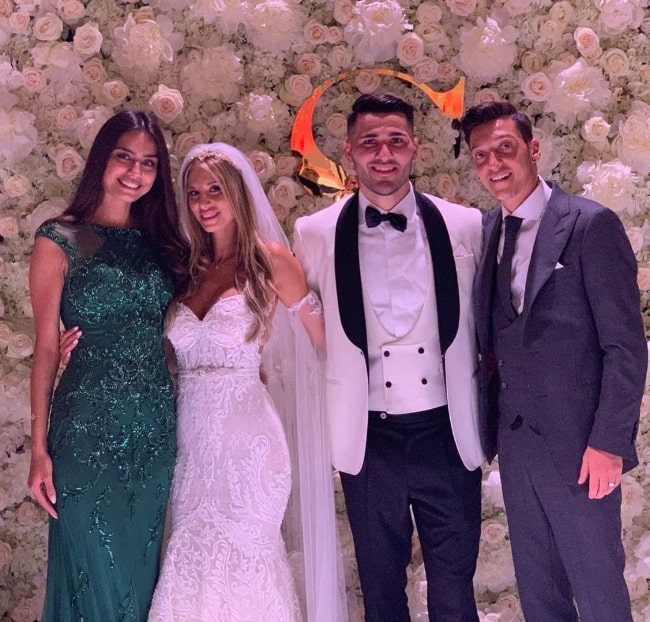 Amine Gülşe as seen while posing for a picture alongside the bride and the groom, Susubelle Kolašinac and Sead Kolašinac, along with Mesut Özil in June 2019