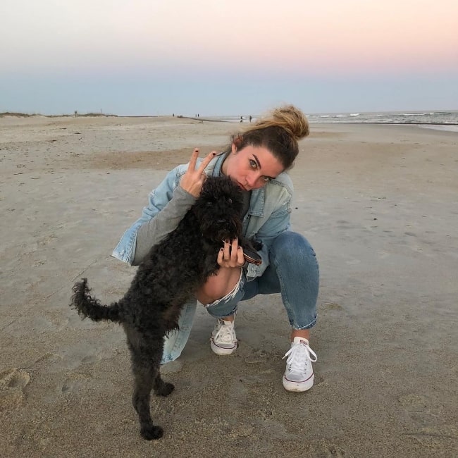 Annie Murphy as seen while posing for a picture with a stunning backdrop alongside her adoptive dog at Wrightsville Beach in New Hanover County, North Carolina, United States in February 2018