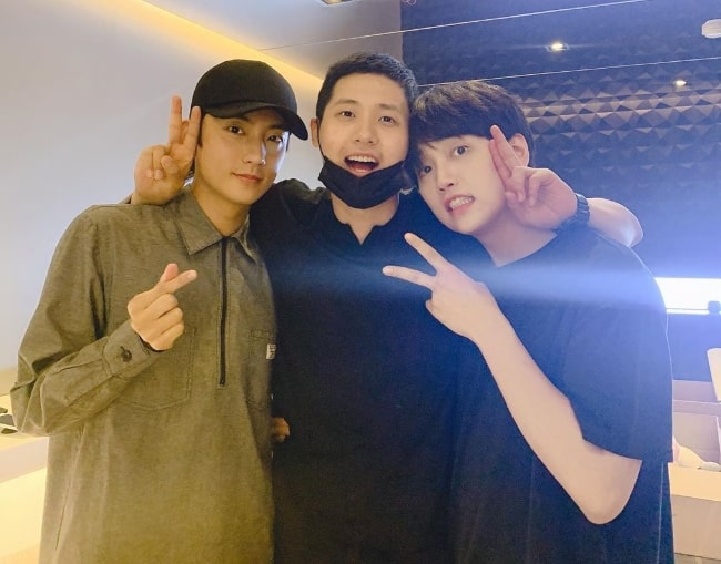 CNU as seen while posing for a picture along with his fellow 'B1A4' artists, Gongchan (Left) and Sandeul (Right), in May 2019