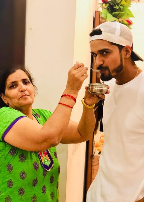 Deepak Hooda as seen in a picture taken with his mother in May 2018