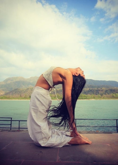 Ira Trivedi as seen in a picture taken while performing her yoga in a scenic background in December 2019