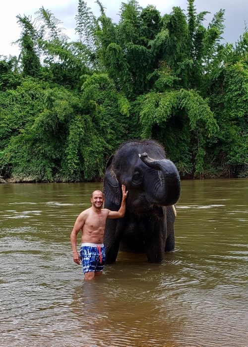 Jase Bennett as seen while posing for a picture alongside an elephant at Erawan National Park in Thailand in August 2019