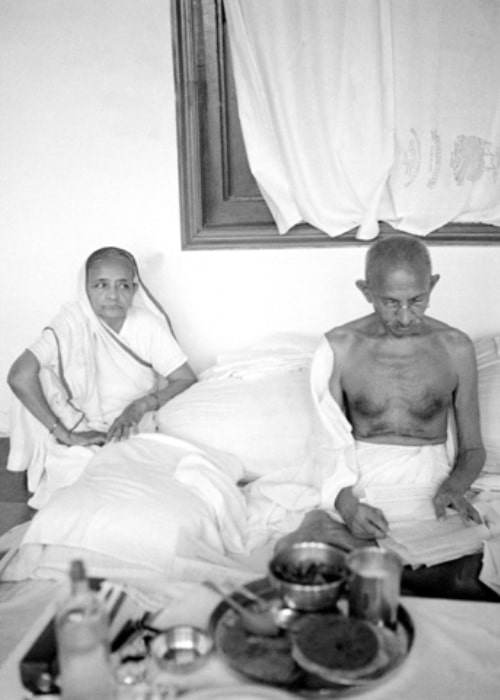 Mahatma Gandhi as seen in a picture with his wife Kasturbai Gandhi while reading