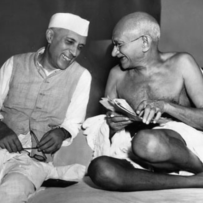 Mahatma Gandhi in a picture taken with Jawaharlal Nehru while they joke during a meeting of the All India Congress in Mumbai on July 6, 1946